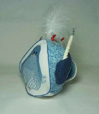 Happy Jay weighted stand-up pincushion holding scissors and a needle